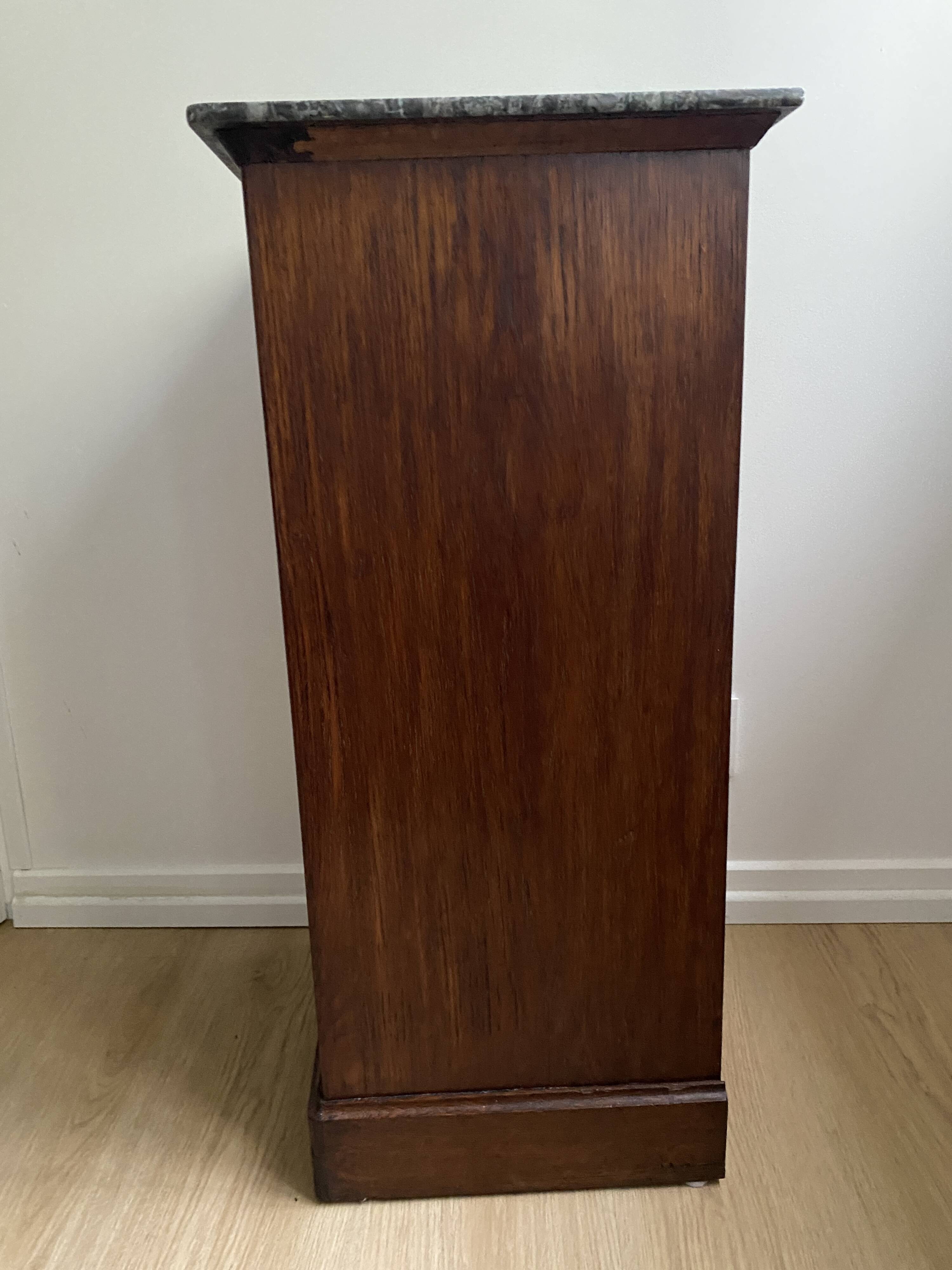 Vintage bedside table in the shape of a wooden column and a gray marble top