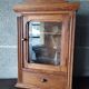 Old glass wall shelf with drawer door