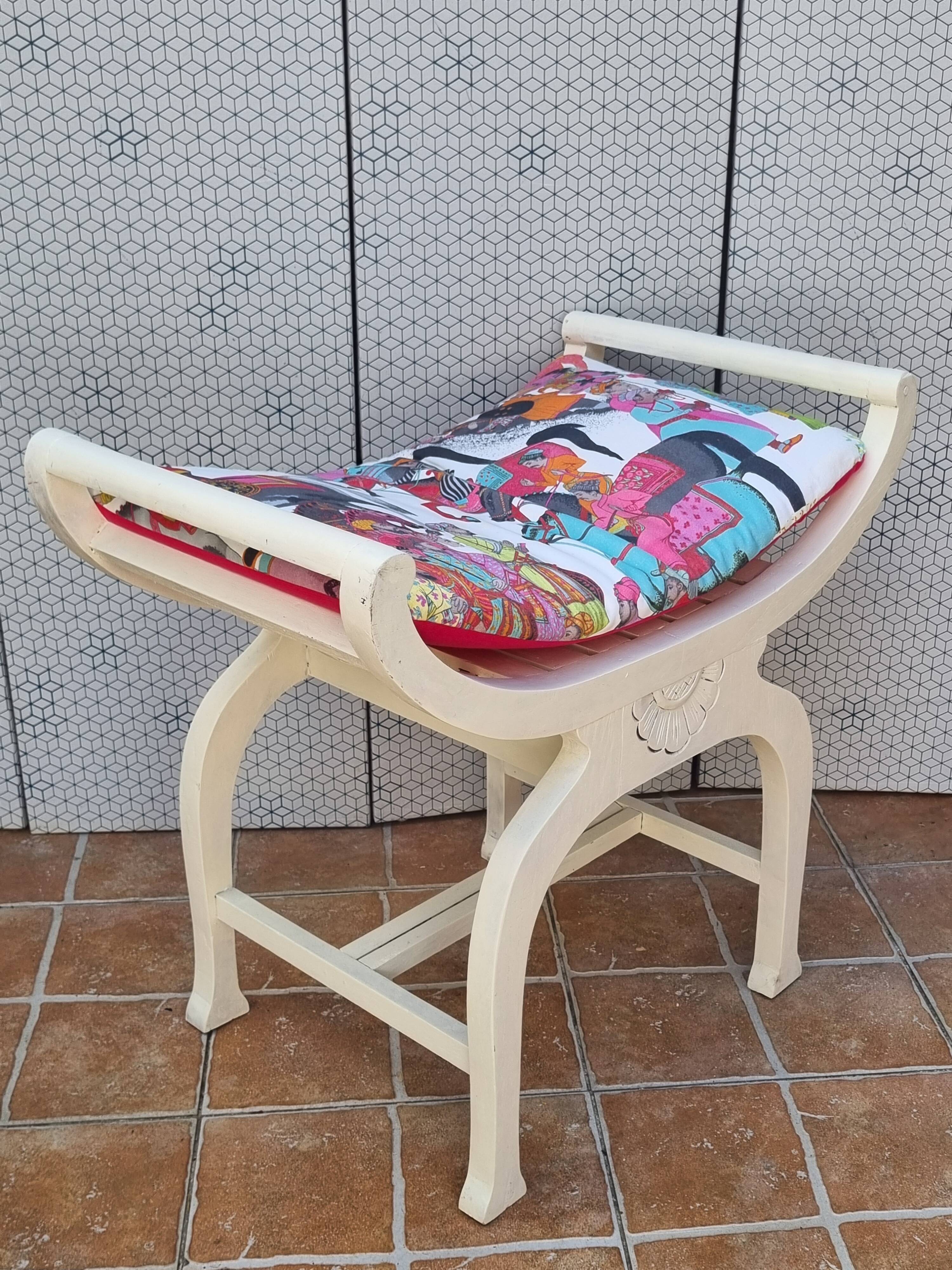 Curule stool in patinated carved wood, Manuel Canovas seat, 60 cm