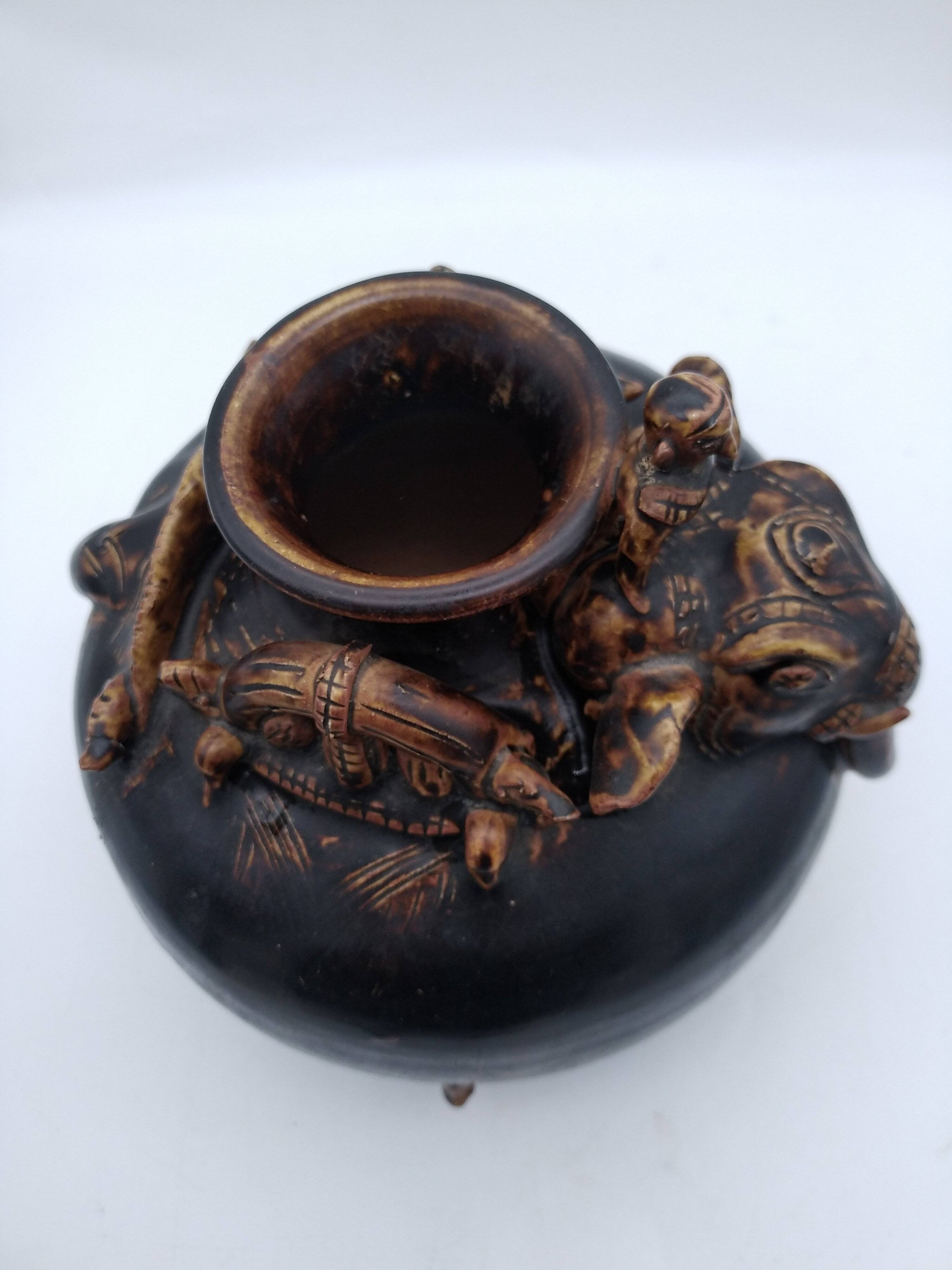 Antique Khmer ceramic vase. With elephant decoration.