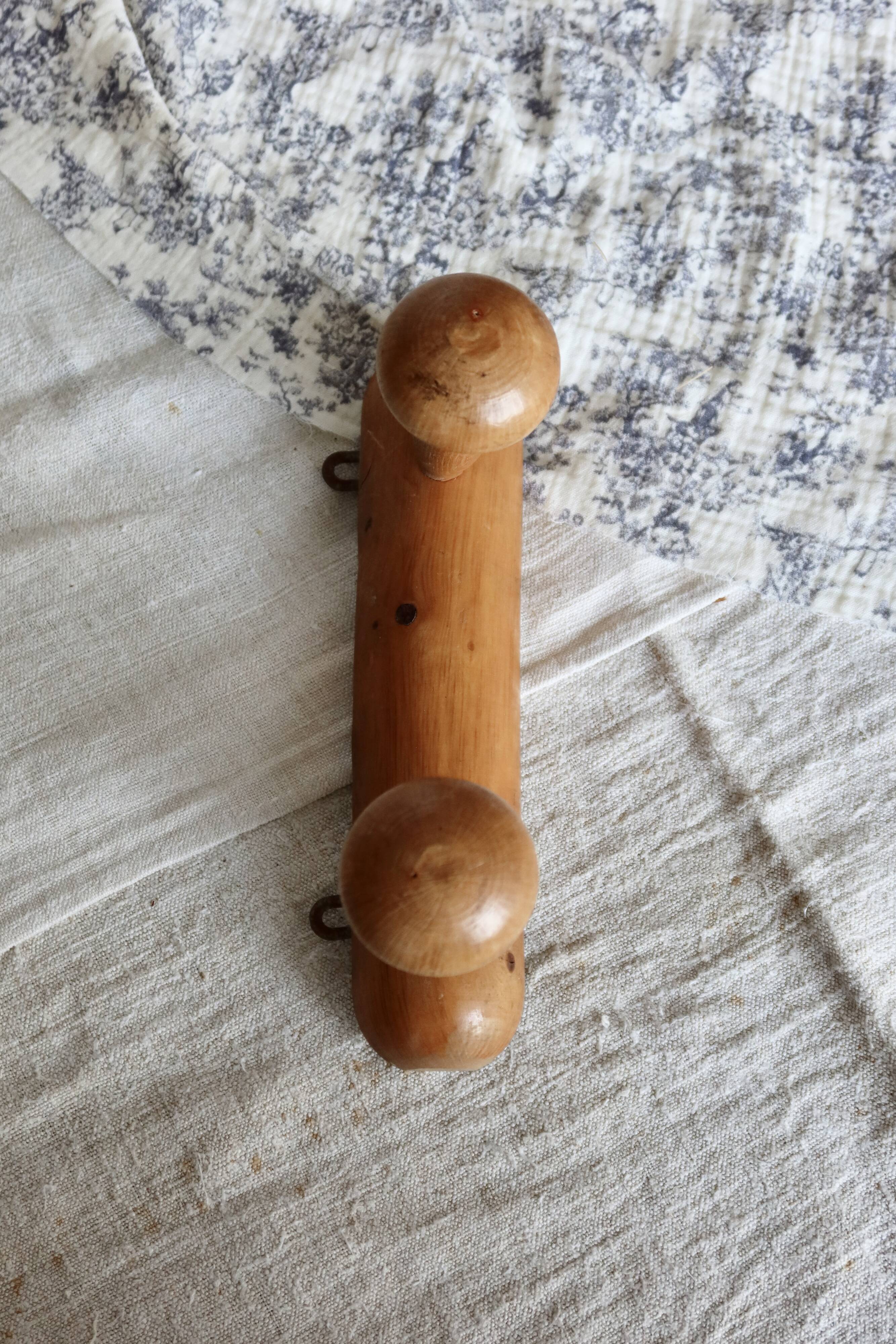 Antique wooden coat rack with two round hooks