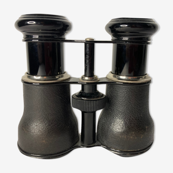 Old pair of binoculars sheathed leather black silver metal