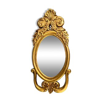 Miroir à vue ovale en bois doré à décor feuillagé de style Régence