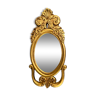 Miroir à vue ovale en bois doré à décor feuillagé de style Régence
