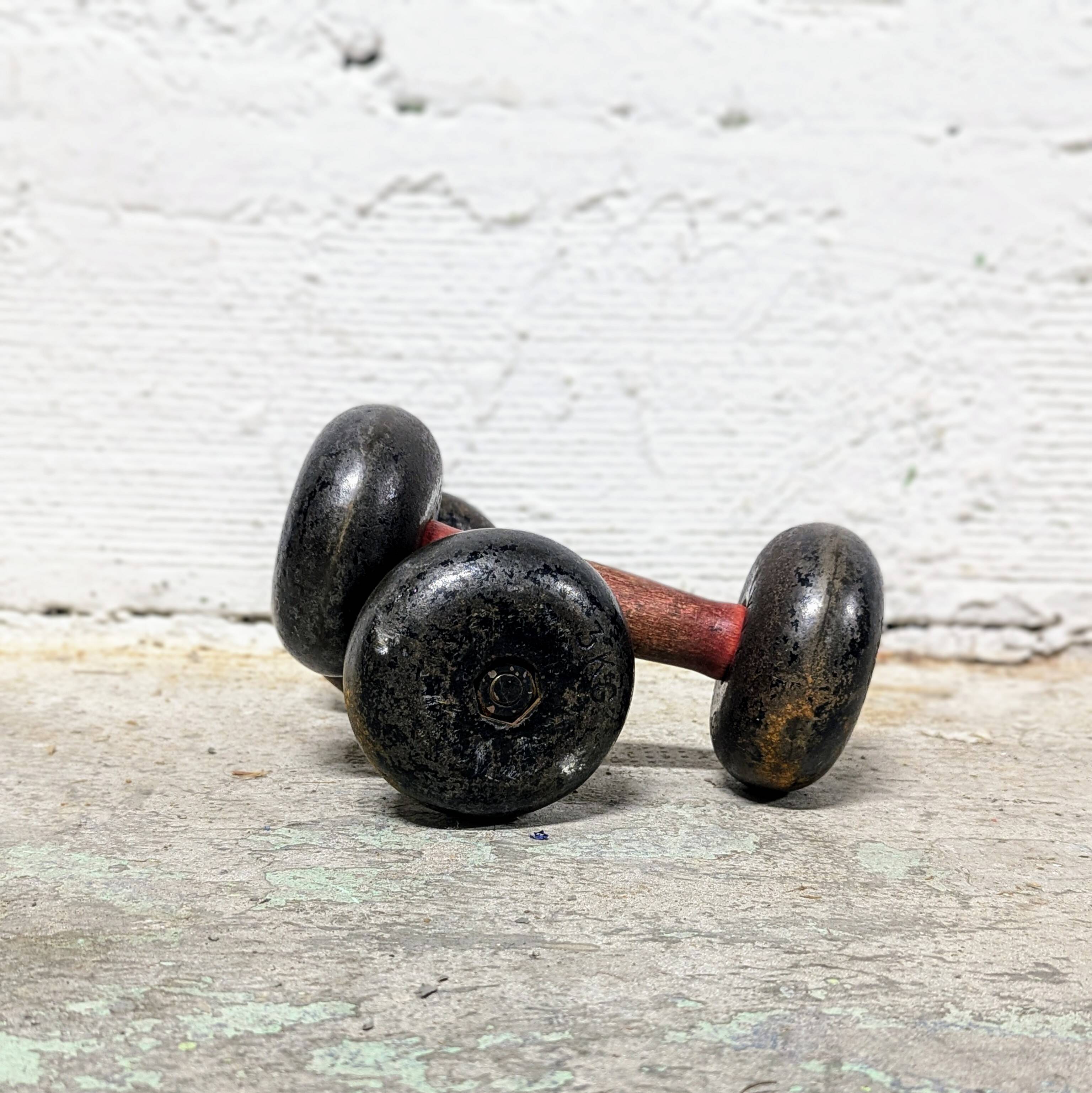 Pair of vintage cast iron and wood dumbbells