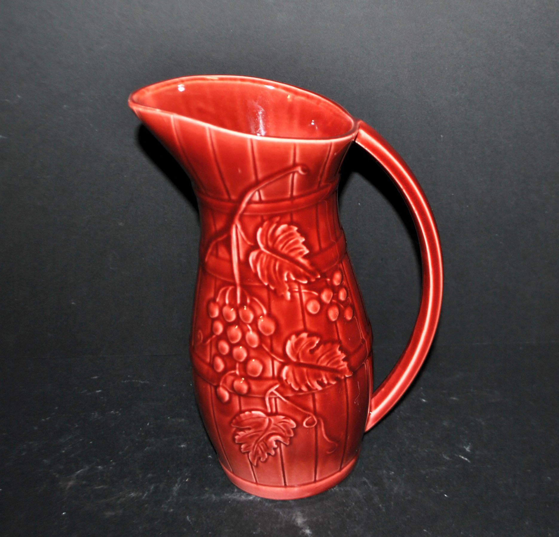 Sarreguemines wine jug in red slipware with grapevine decoration.