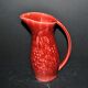 Sarreguemines wine jug in red slipware with grapevine decoration.