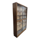 Vintage shallow wooden display shelf with sliding glass doors.