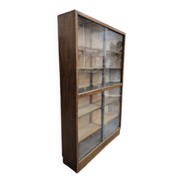 Vintage shallow wooden display shelf with sliding glass doors.