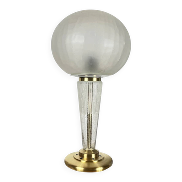Large globe table lamp with a cracked glass base and brass stand.