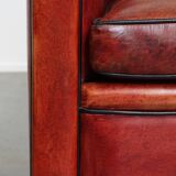 Armchair made of sheepskin leather in a red/brown color