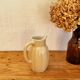 Vintage cream ceramic jug in a chic country style.