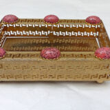 Empty pocket in gold metal and pink stones