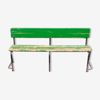 Former wooden school bench painted green and rusty metal stomping