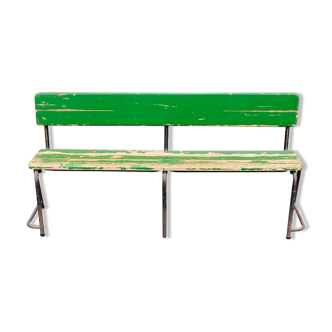 Former wooden school bench painted green and rusty metal stomping