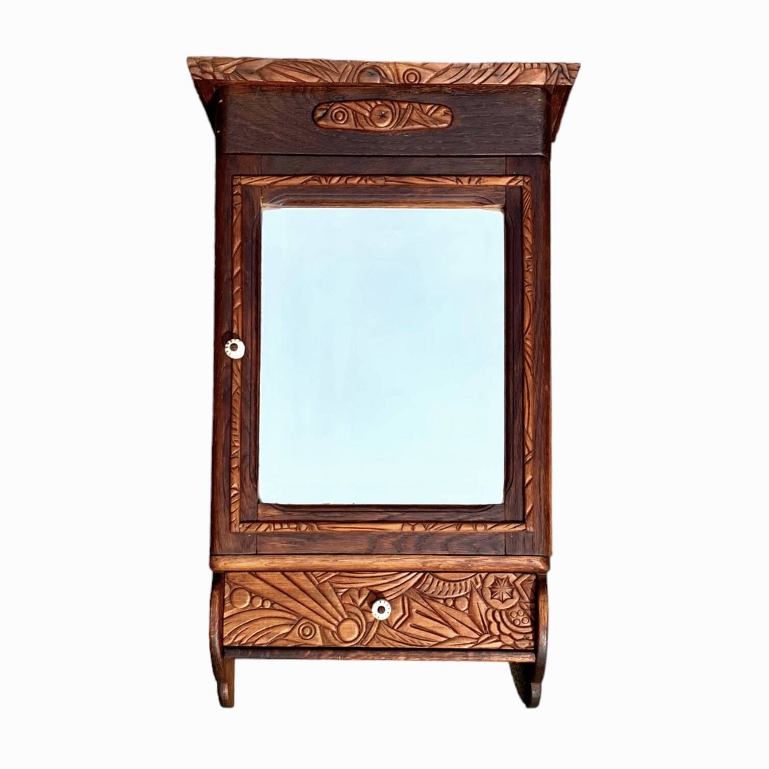 Old carved wooden medicine cabinet with beveled mirror