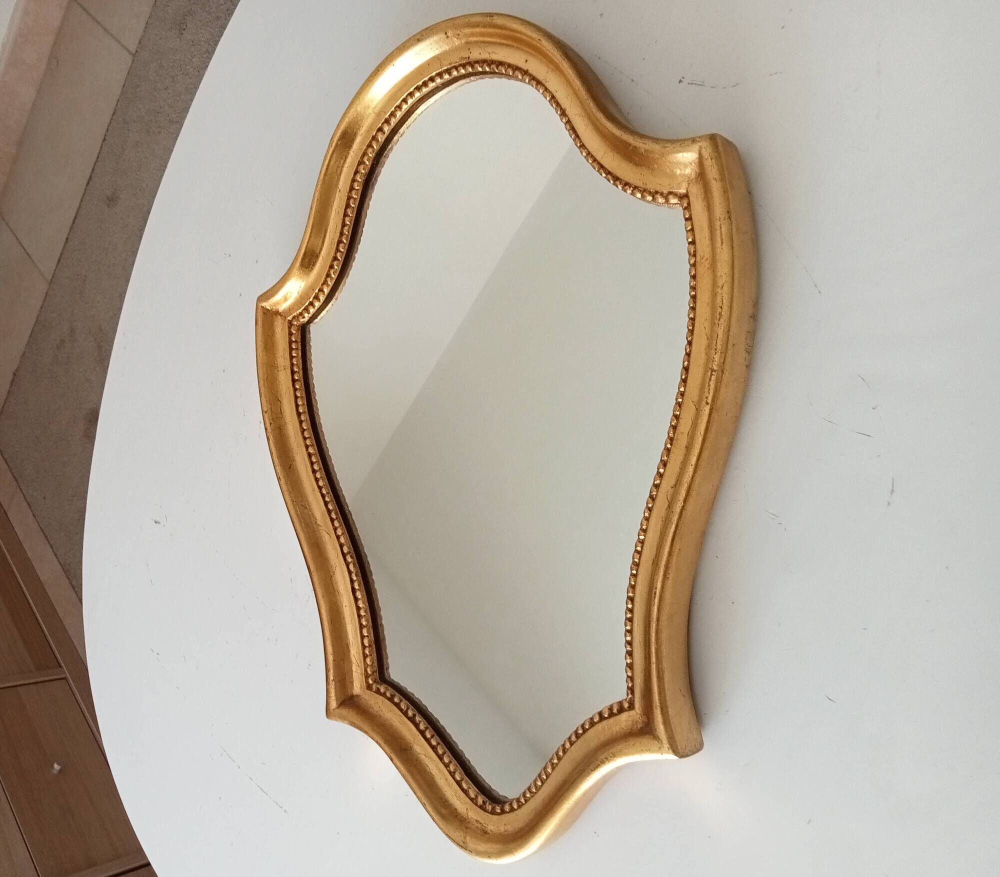 Vintage baroque mirror in gilded wood in the Louis XV style.