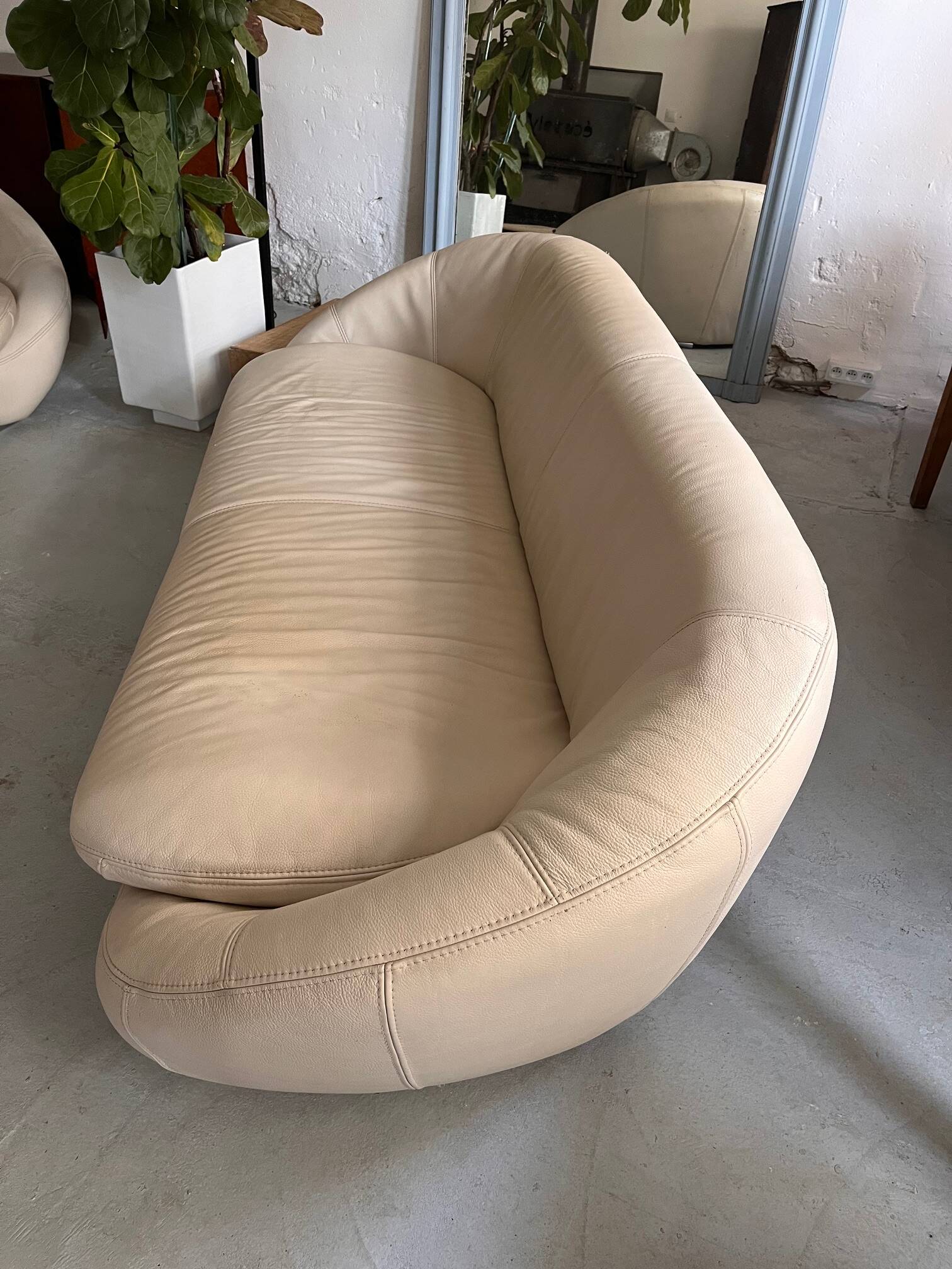 Rounded off-white leather sofa