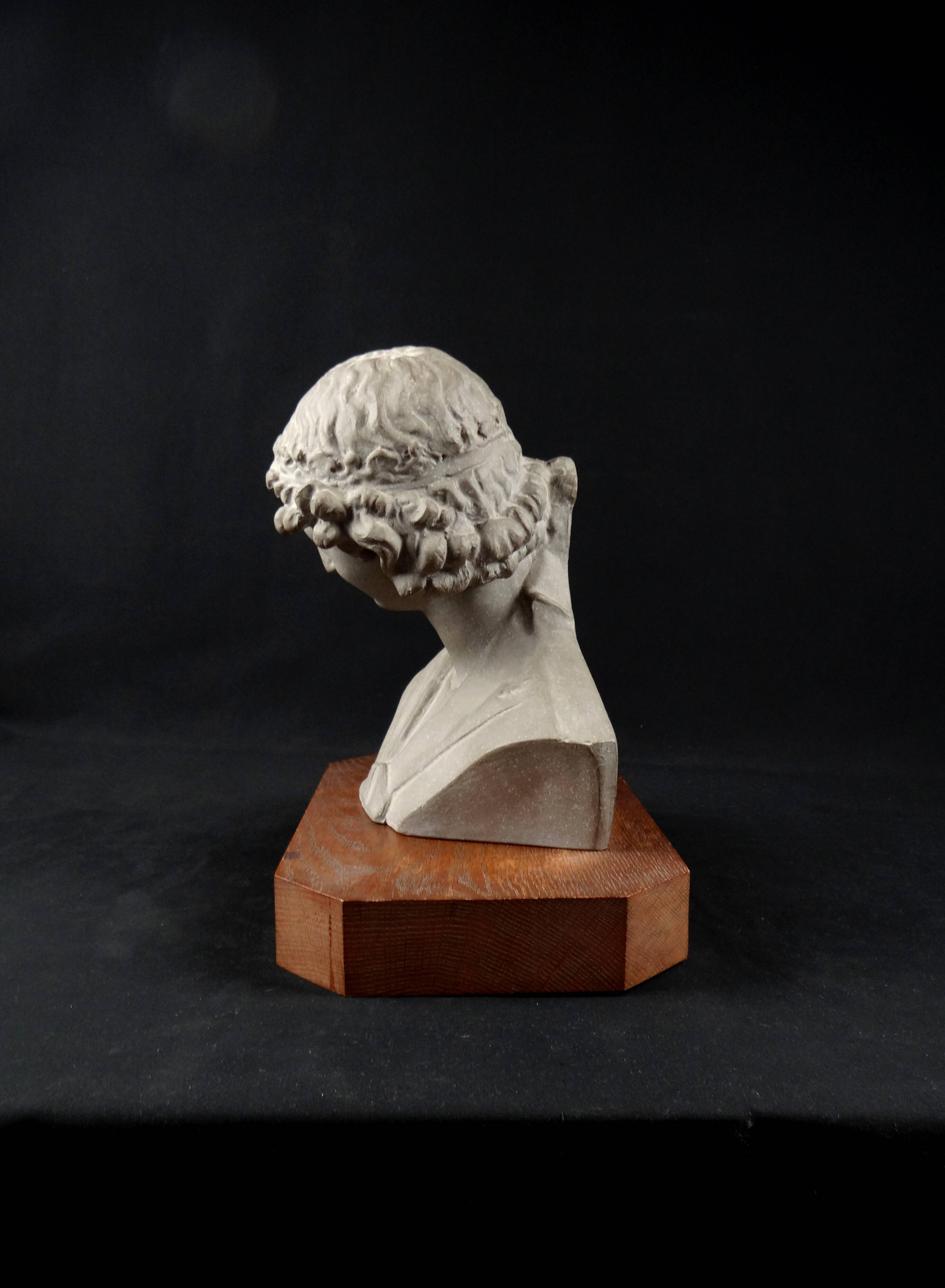 Terracotta bust of the smiling angel from Reims Cathedral with base