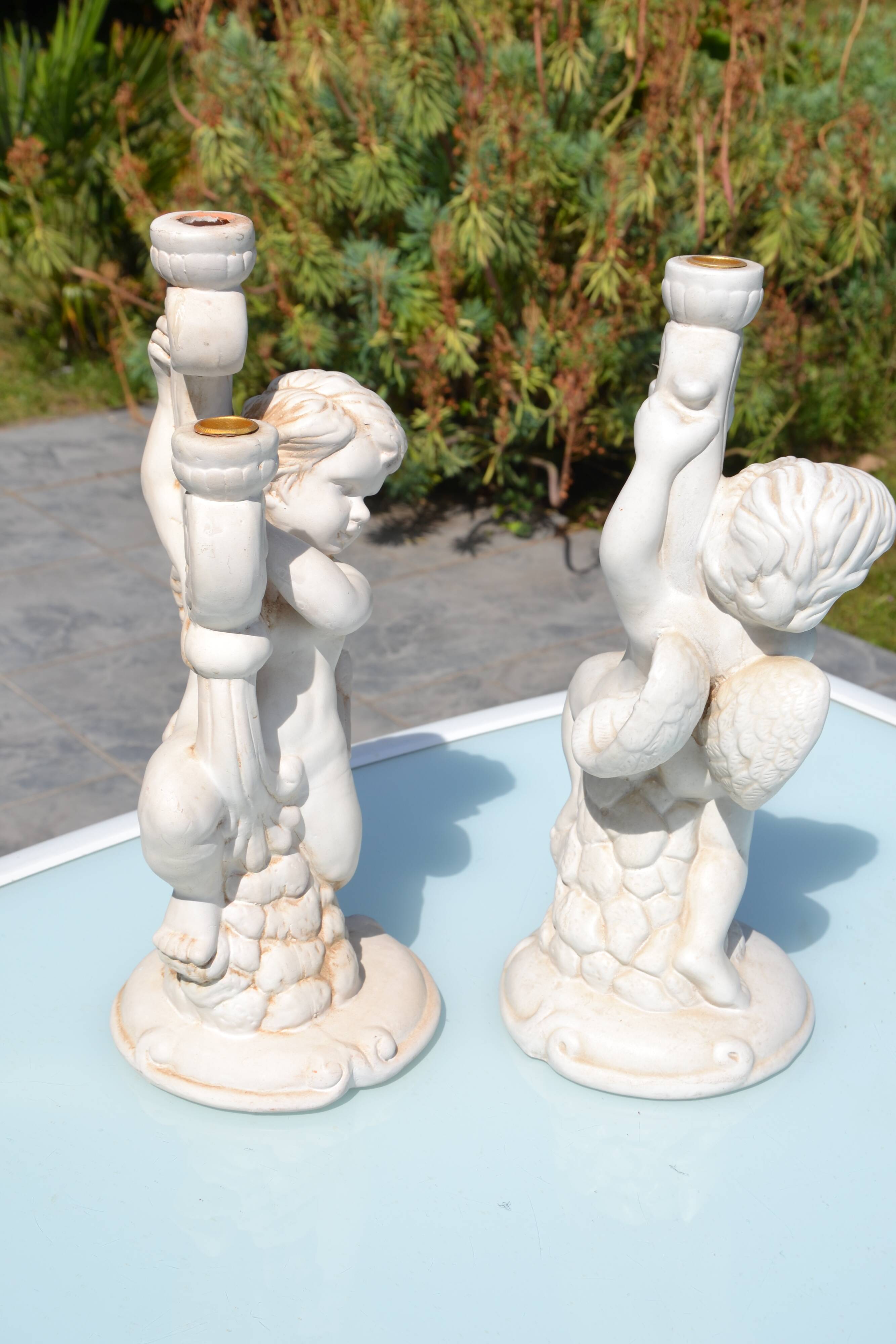 Pair of "cherub" candle holders in plaster