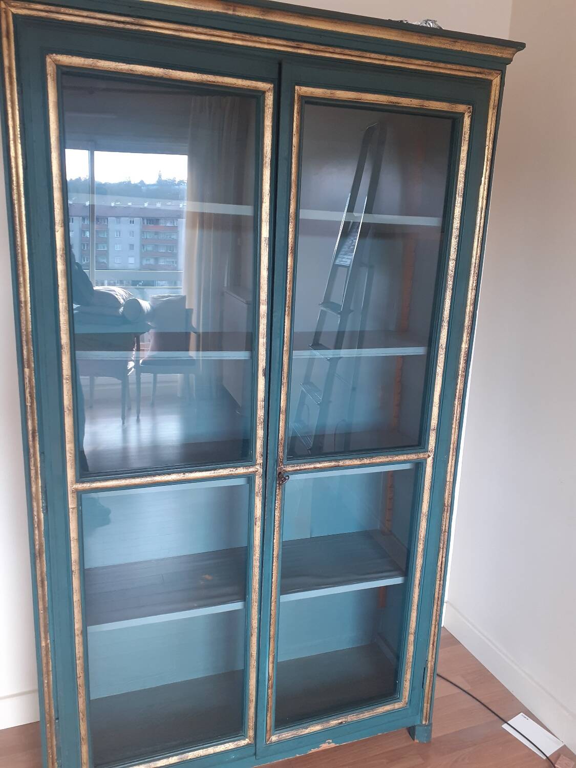 Glass-fronted cabinet in weathered green wood