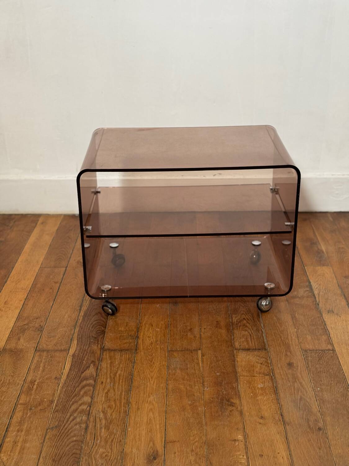 Smoked Plexiglas coffee table on wheels -