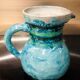 Old pitcher in terracotta signed