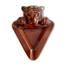 Brown ashtray with lion's head.
