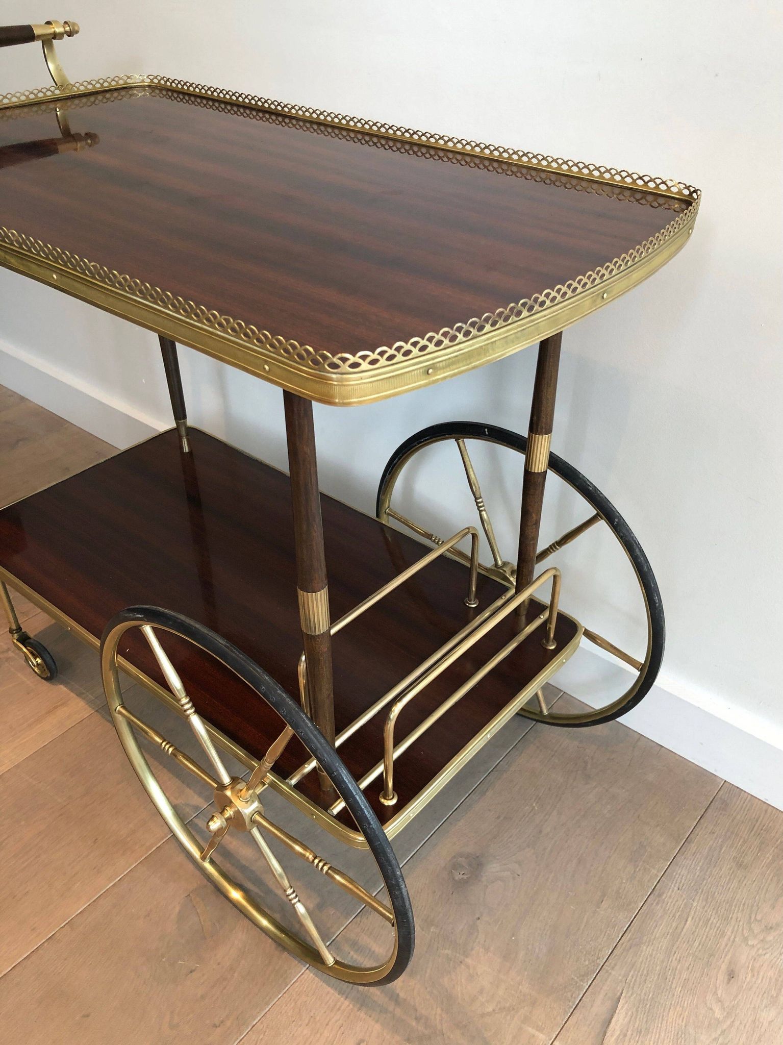 Mahogany and brass rolling table in the style of Maison Jansen.