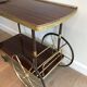 Mahogany and brass rolling table in the style of Maison Jansen.