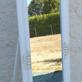 Large wooden mirror on tilting psyche stand in whitewashed gold with molding