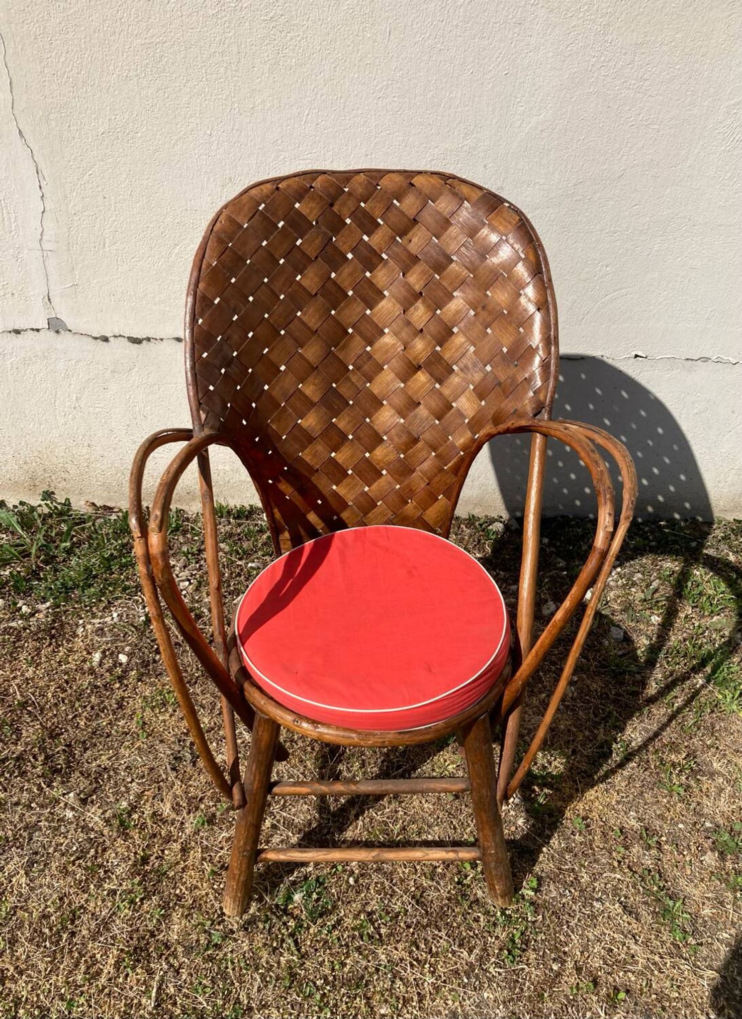 Vintage 1970s armchair in curved woven chestnut + seat cushion