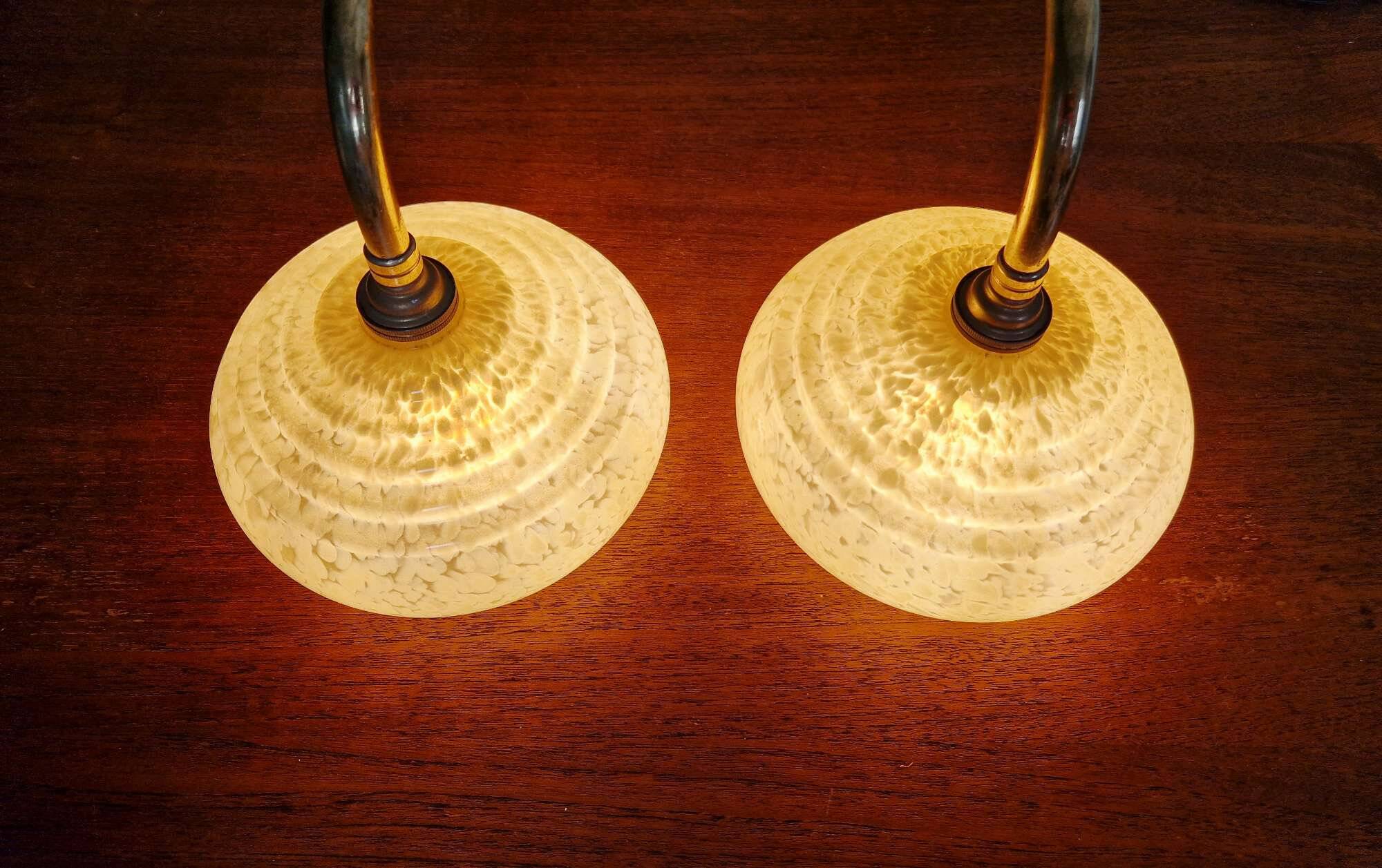 Pair of brass and yellow/white speckled glass wall sconces