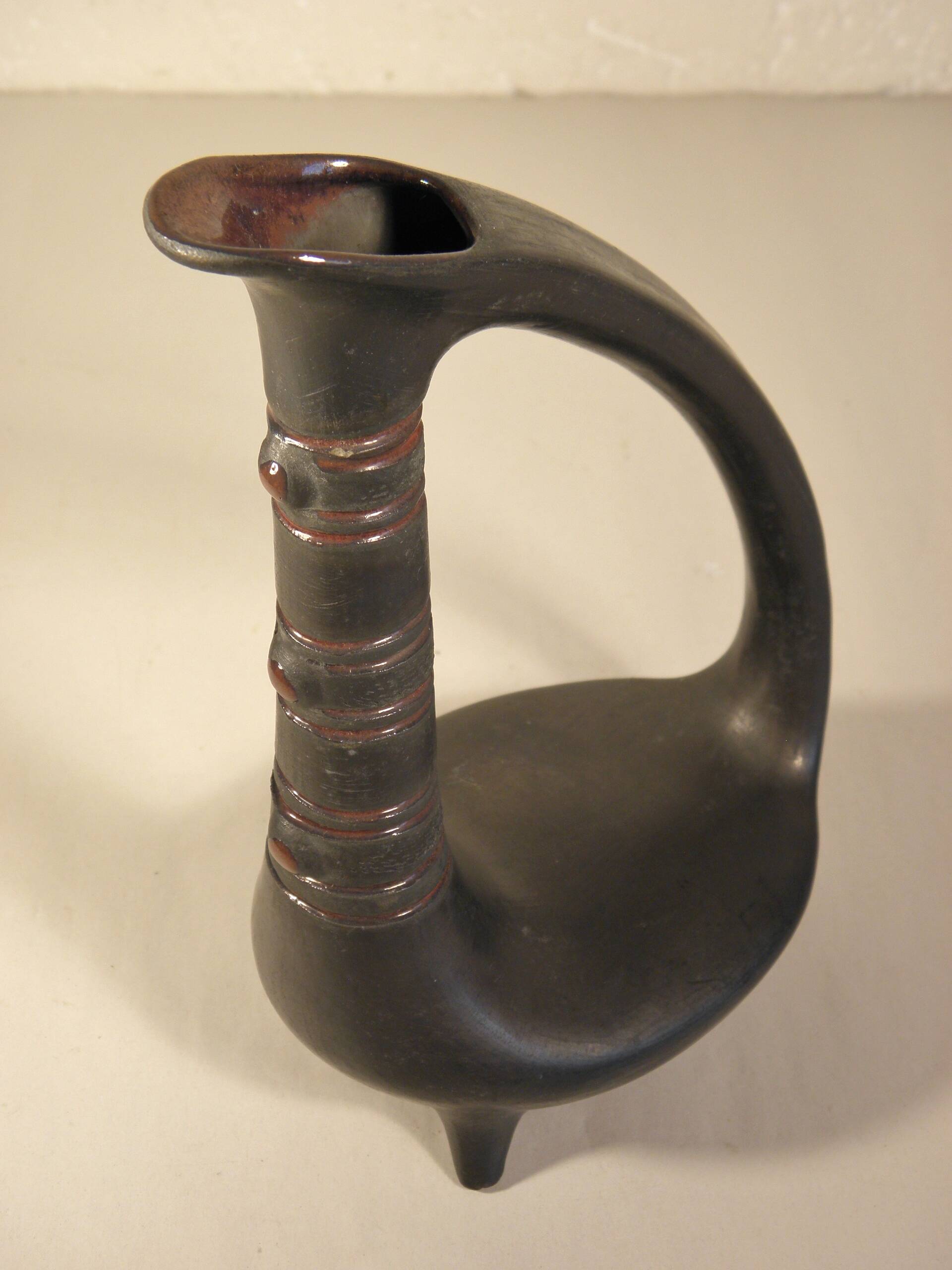 Zoomorphic pitcher vase in black ceramic