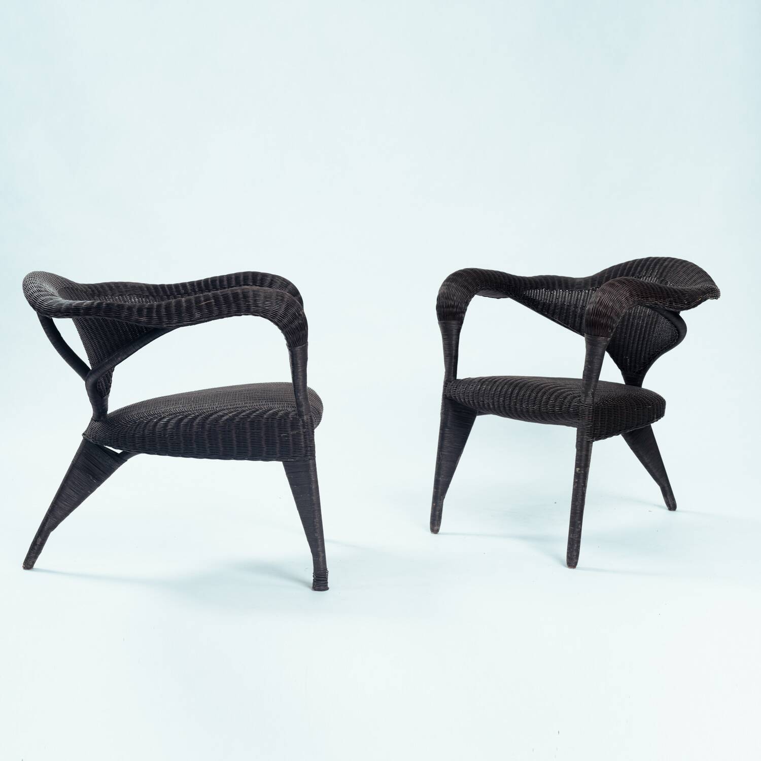 Sculptural rattan tripod armchairs in the manner of Boris Sipek