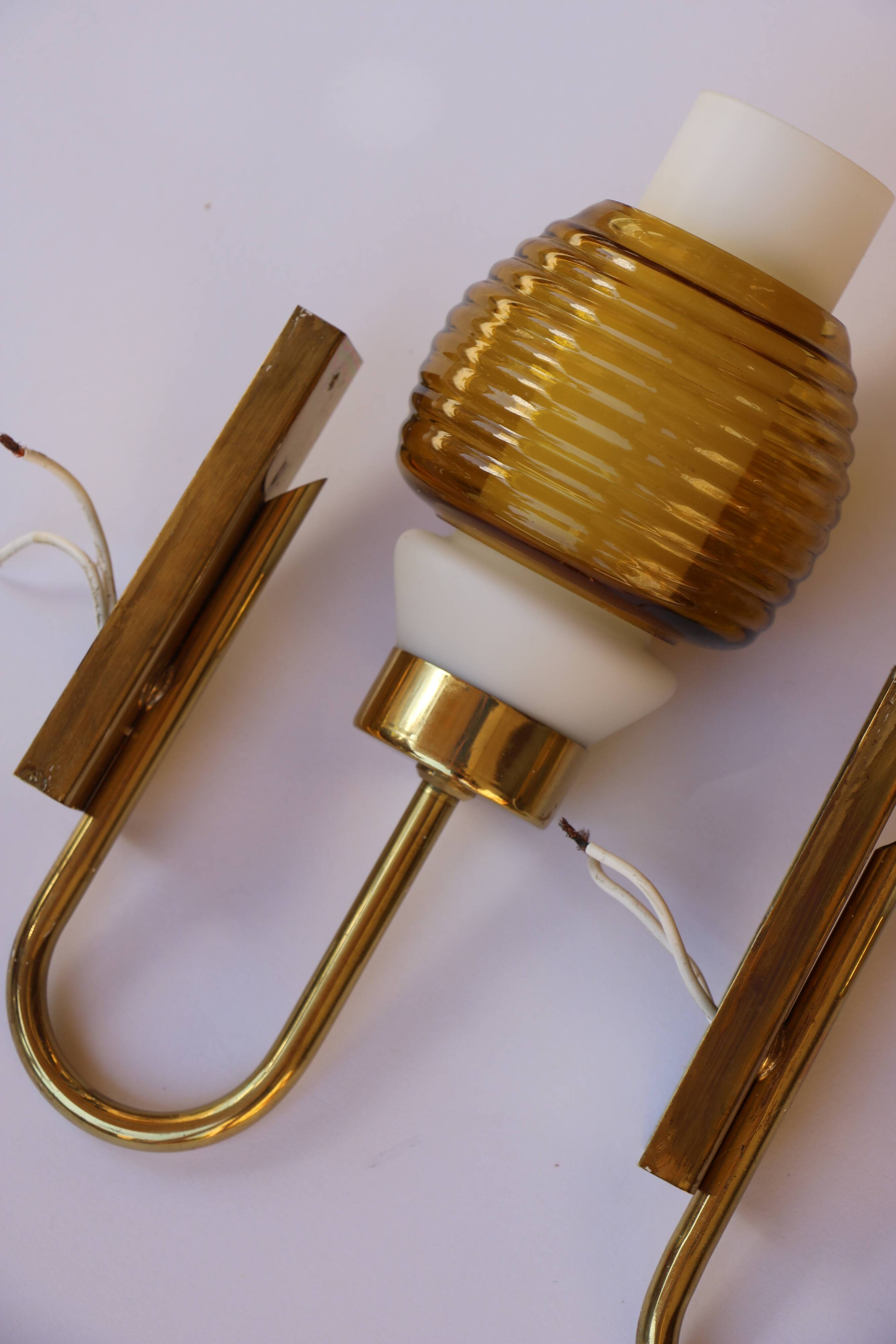 Pair of Scandinavian wall sconces, brass, opal glass and amber glass.