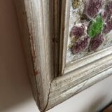 Large square ceramic mirror with floral decoration.