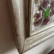 Large square ceramic mirror with floral decoration.
