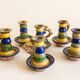 Many old glazed terracotta candlesticks.