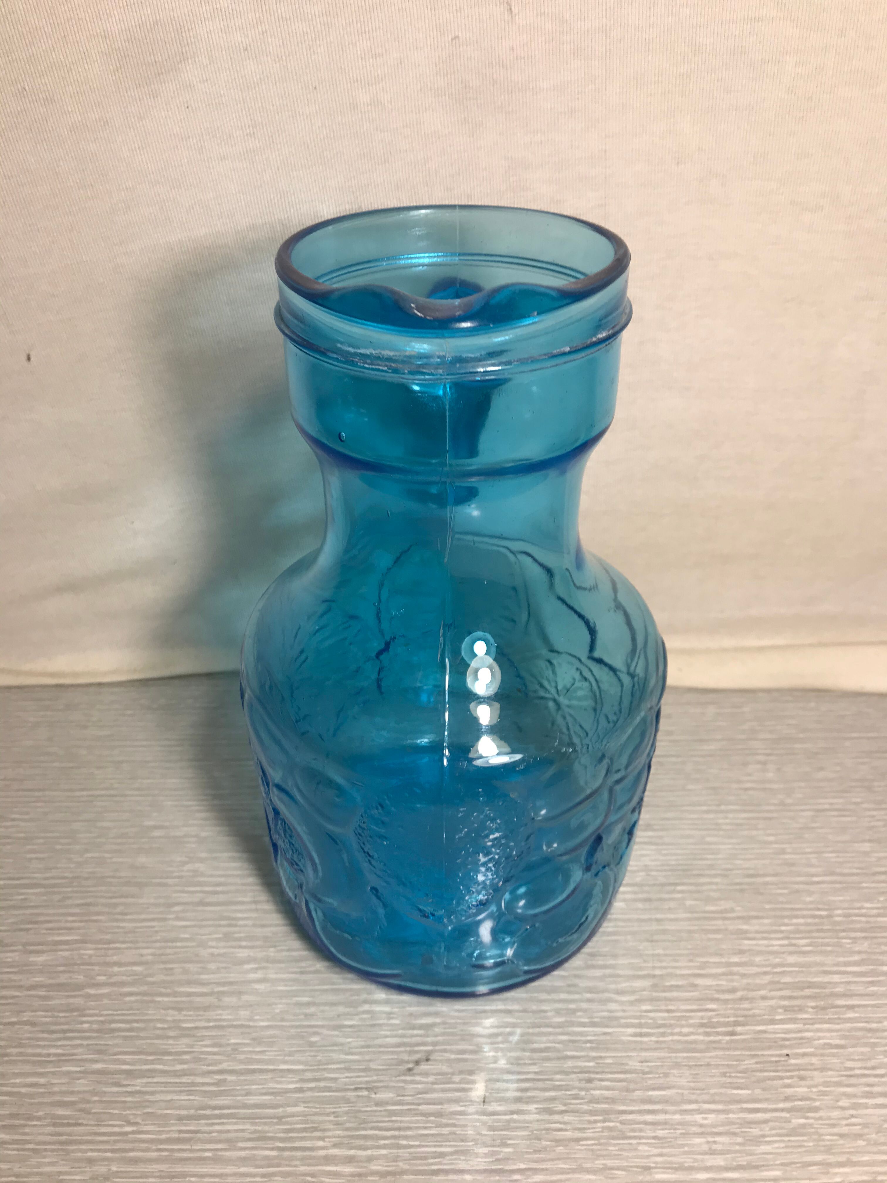 Blue moulded pitcher with decorative handle