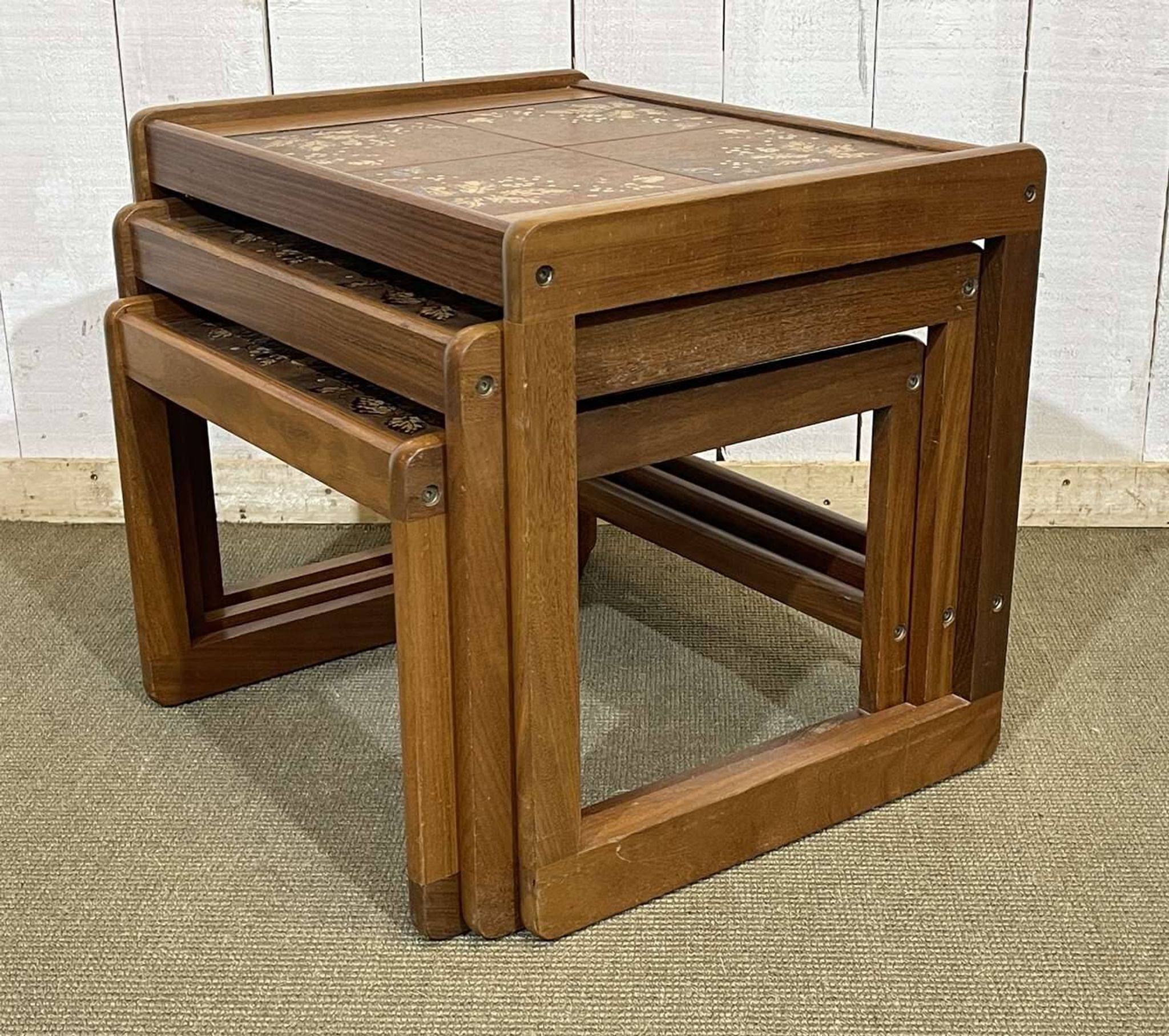 Set of 3 nesting tables in teak with tiled tops.