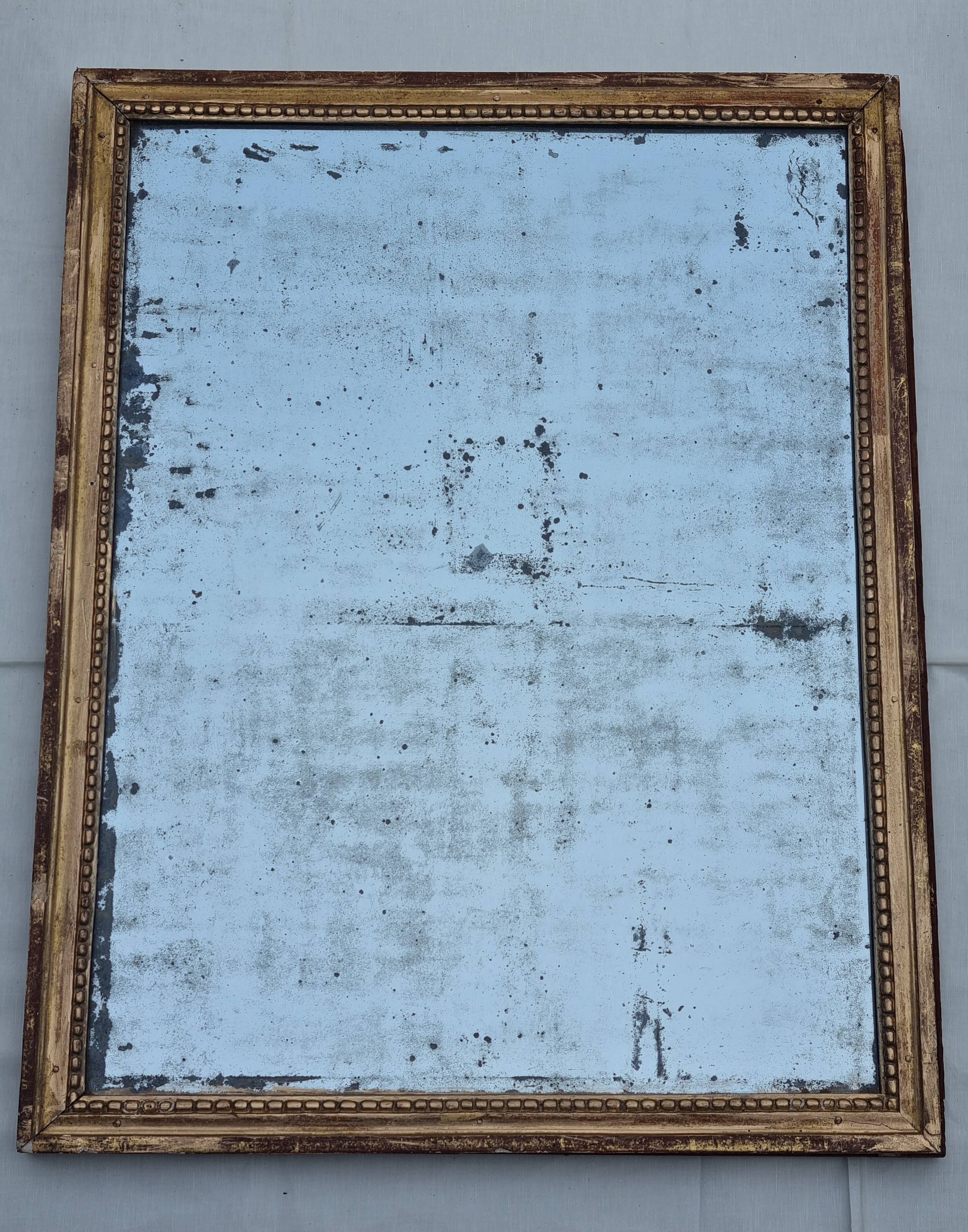 Antique mirror in a gilded wooden frame in the Louis XVI style, 19th century, 62x78 cm.