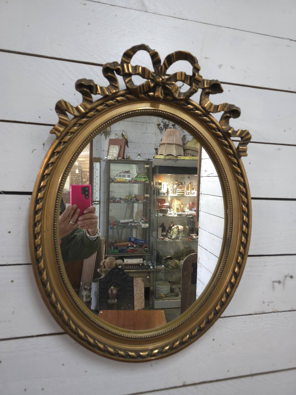 Oval mirror with gold patina