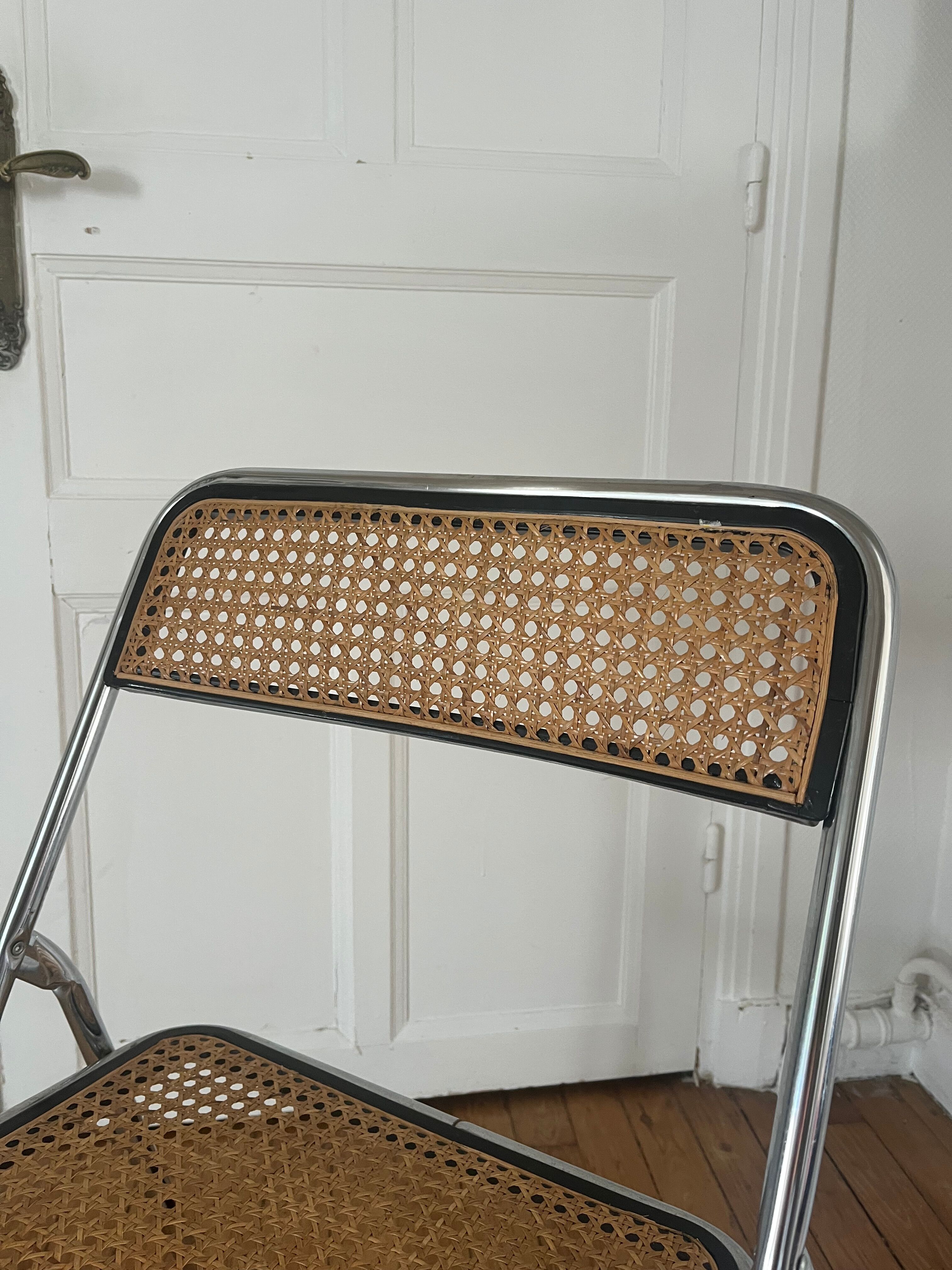 Vintage folding chair in metal and cane.