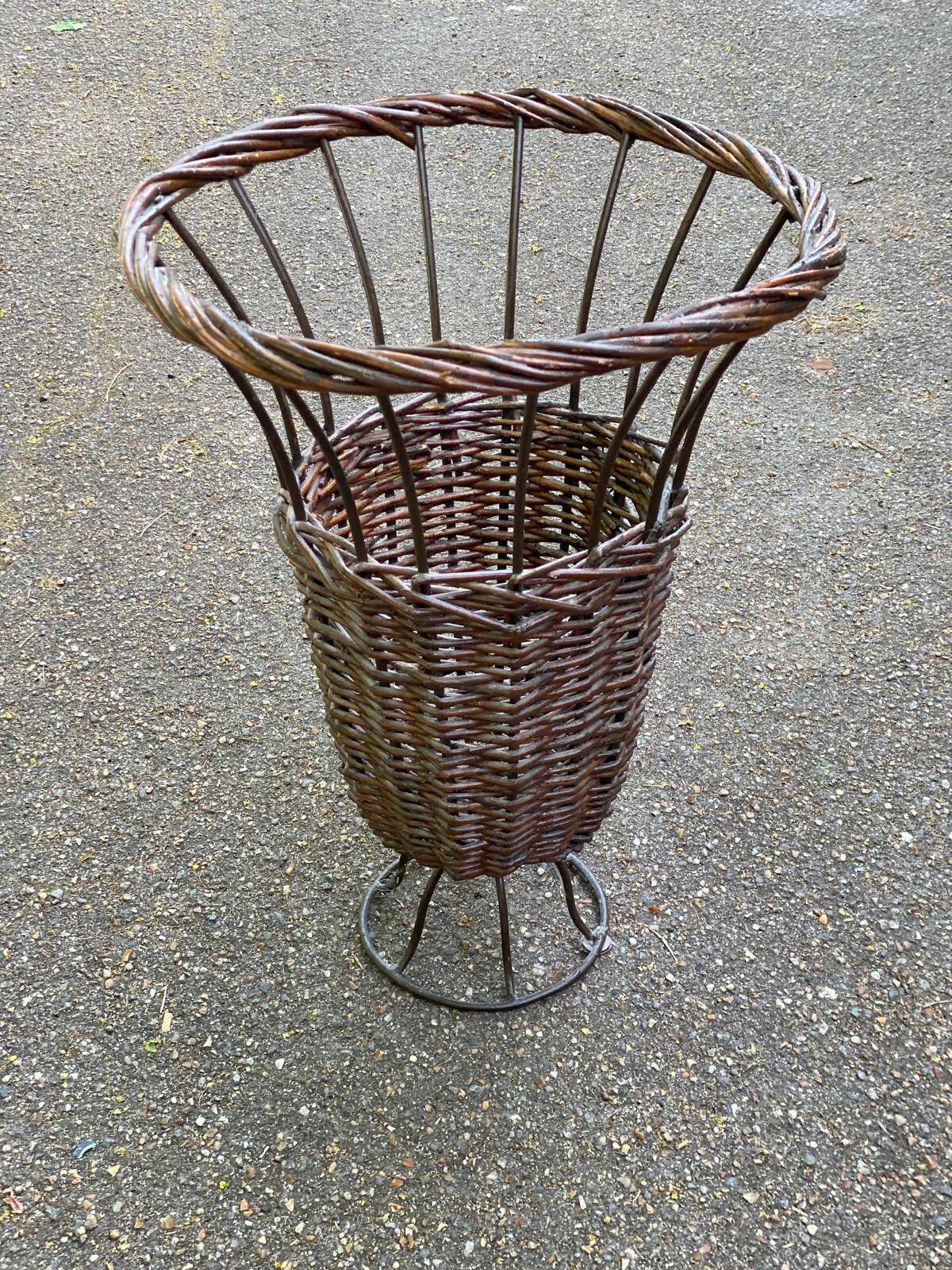 Vintage umbrella stand in rattan, woven wicker, and steel.