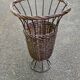Vintage umbrella stand in rattan, woven wicker, and steel.
