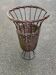 Vintage umbrella stand in rattan, woven wicker, and steel.