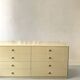 Commode type sideboard with 8 drawers, ivory lacquer and brass details, 1970s design.