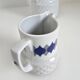 Vintage Schirnding Bavaria coffee pot and milk jug, blue geometric pattern.