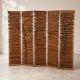 Wooden screen with slats, black plant decoration.